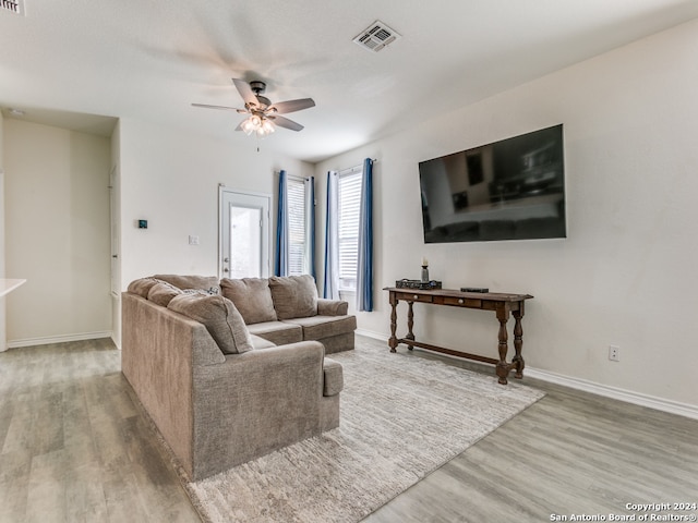 living room featuring ceiling fan and hardwood / wood-style floors