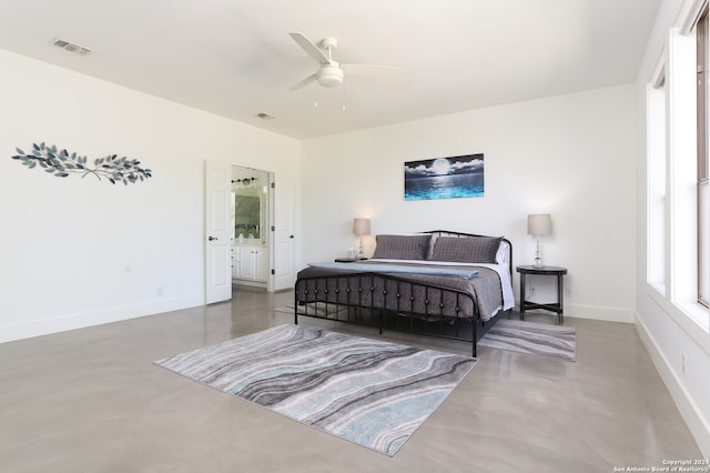 bedroom featuring connected bathroom, ceiling fan, and concrete flooring