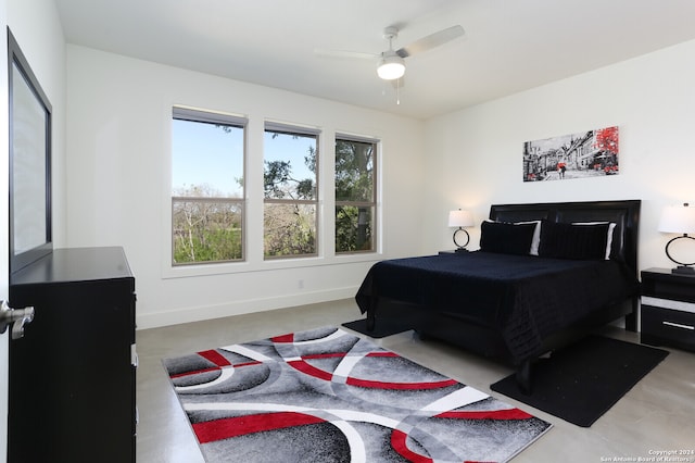 bedroom with ceiling fan and concrete floors