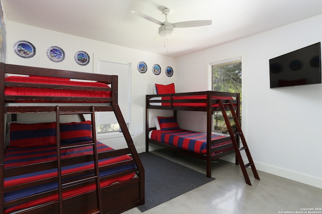 bedroom with concrete floors and ceiling fan