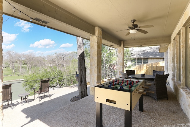 view of patio featuring a balcony and ceiling fan