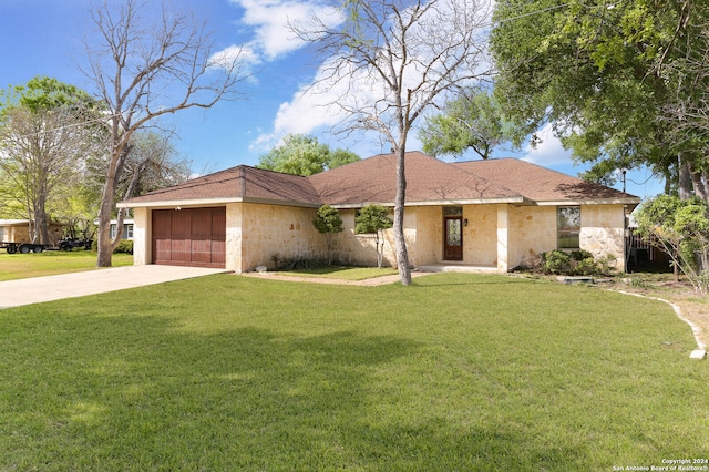 single story home with a garage and a front lawn