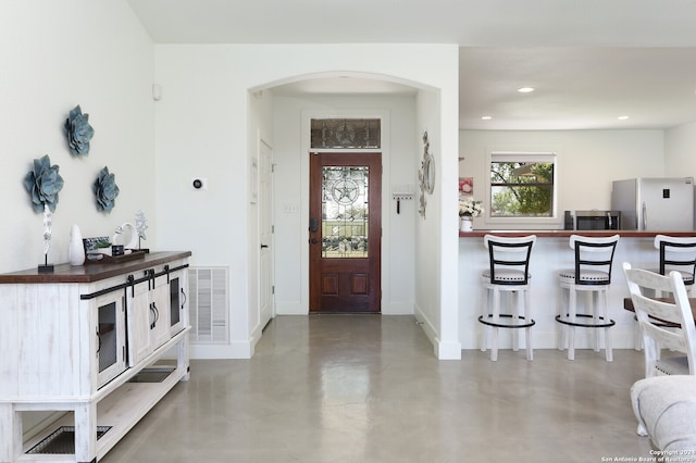 foyer entrance featuring concrete floors