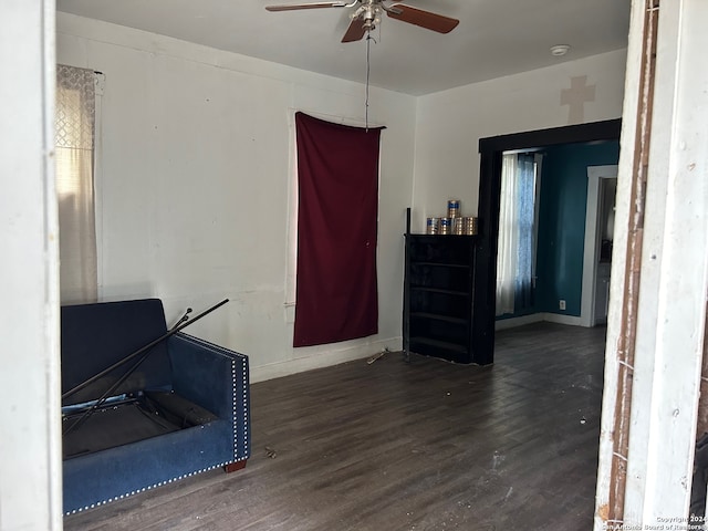 interior space with ceiling fan and dark wood-type flooring