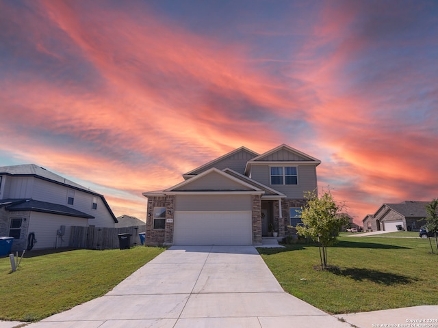 view of front facade with a lawn and a garage