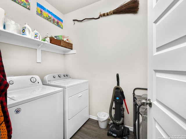 clothes washing area featuring washing machine and dryer and dark hardwood / wood-style flooring