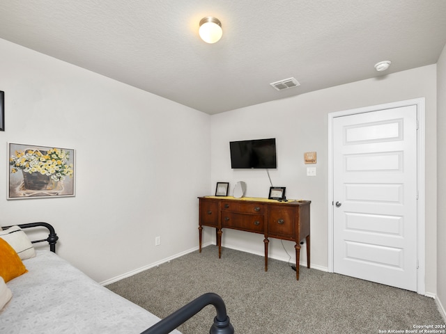 carpeted bedroom with a textured ceiling