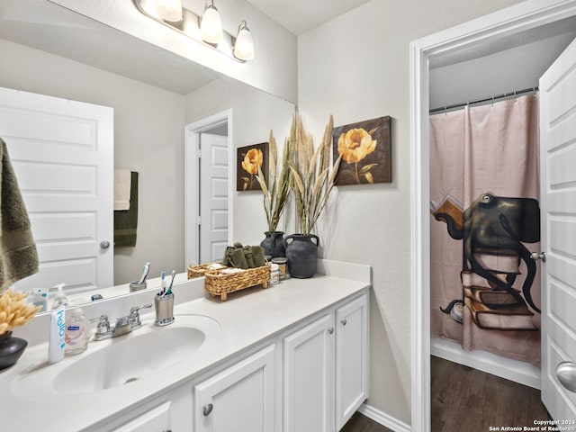 bathroom with vanity and hardwood / wood-style flooring