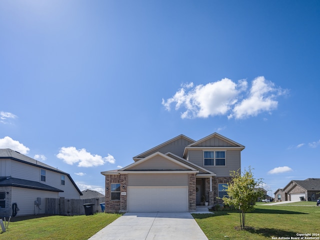 view of front of home featuring a front yard and a garage