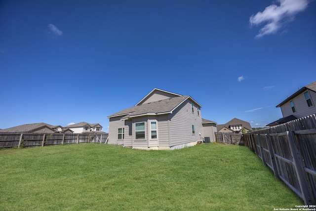 rear view of property featuring a yard