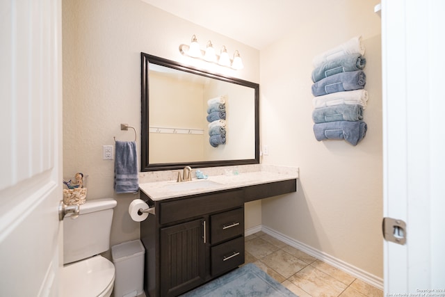 bathroom with tile patterned flooring, vanity, and toilet