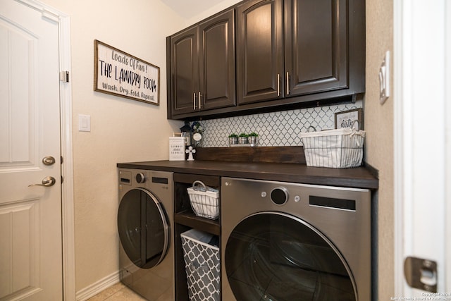 clothes washing area with cabinets, separate washer and dryer, and light tile patterned flooring