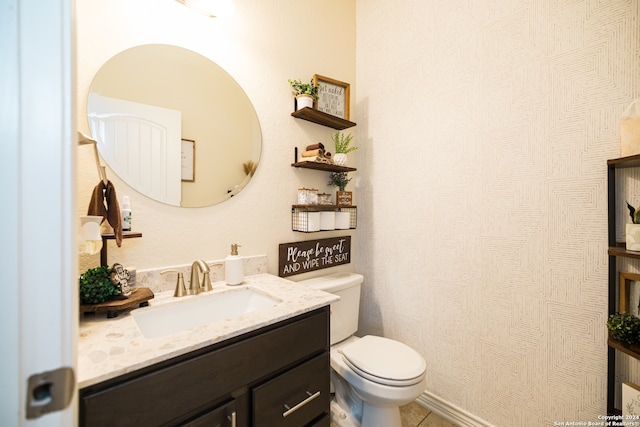 bathroom with tile patterned floors, vanity, and toilet