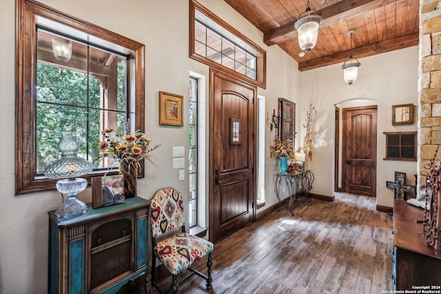 entryway featuring lofted ceiling with beams, dark hardwood / wood-style floors, and wooden ceiling