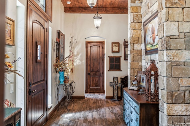 entryway with beam ceiling, dark wood-type flooring, and wood ceiling