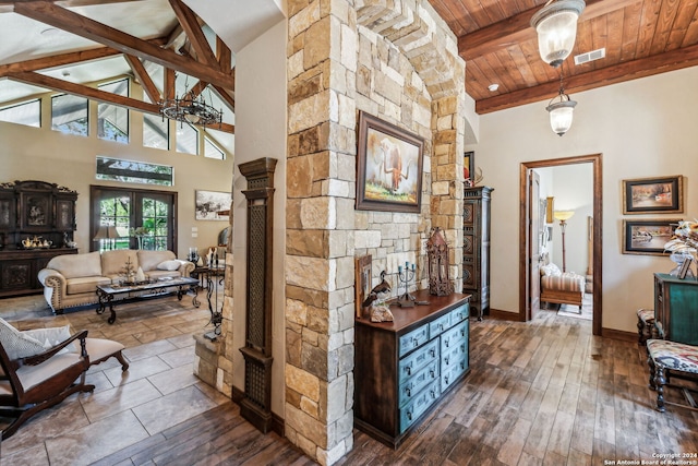 corridor featuring beam ceiling, french doors, high vaulted ceiling, wood-type flooring, and wood ceiling