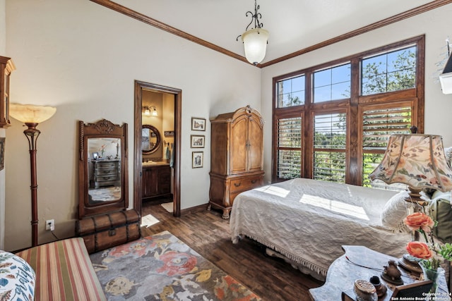 bedroom featuring dark hardwood / wood-style flooring, ornamental molding, and connected bathroom