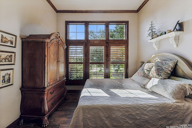 bedroom with dark hardwood / wood-style floors and ornamental molding