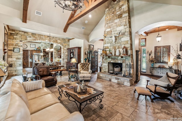 living room with a fireplace, beam ceiling, a chandelier, and high vaulted ceiling