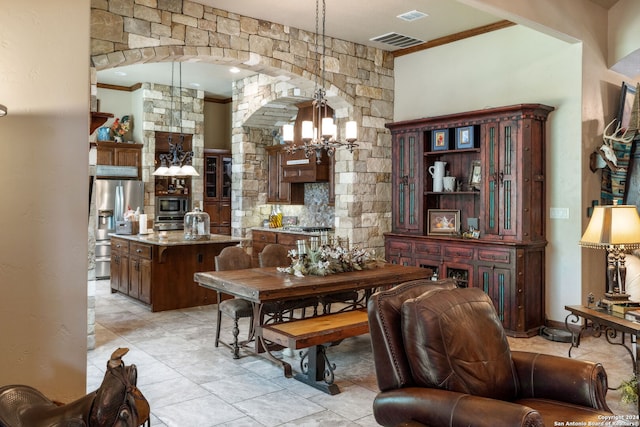 dining room featuring ornamental molding and a chandelier