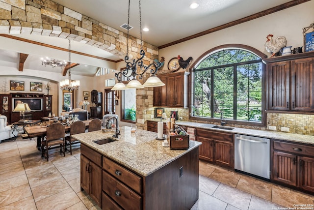 kitchen featuring light stone countertops, dishwasher, sink, hanging light fixtures, and a center island with sink