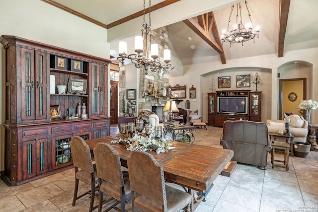 tiled dining space featuring a fireplace, beam ceiling, a chandelier, and high vaulted ceiling