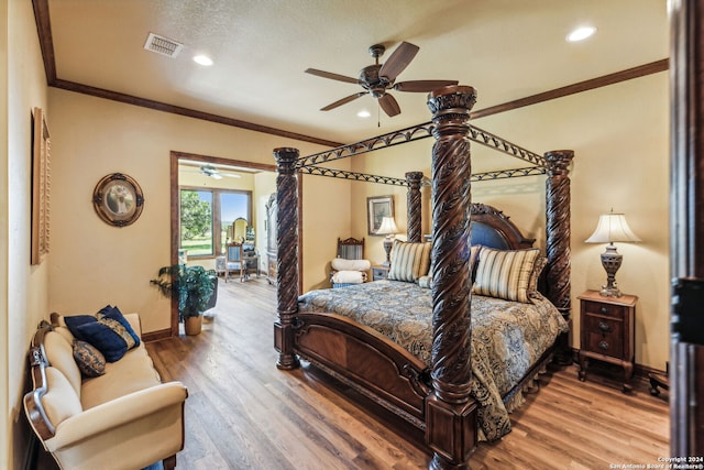 bedroom with wood-type flooring, a textured ceiling, ceiling fan, and ornamental molding