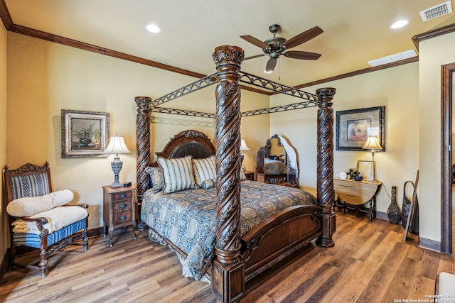 bedroom featuring hardwood / wood-style flooring, ceiling fan, and crown molding