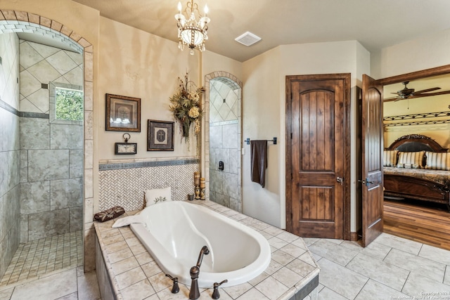 bathroom with ceiling fan and shower with separate bathtub