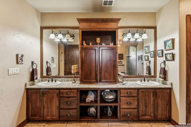 bathroom featuring tile patterned flooring and vanity