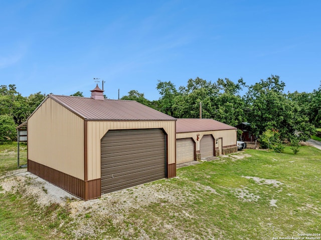 garage featuring a lawn