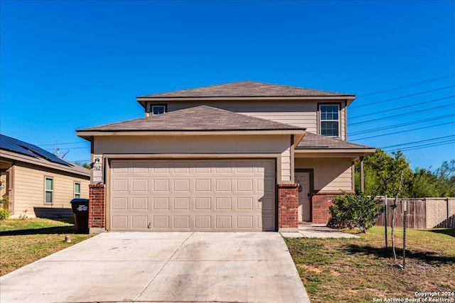 view of front facade featuring a front lawn and a garage