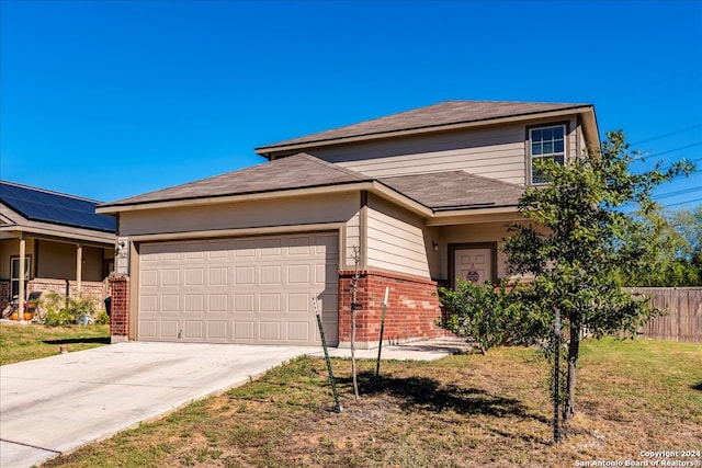 view of front of house with a garage and a front yard