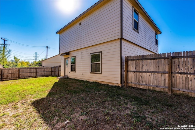 back of house with a lawn