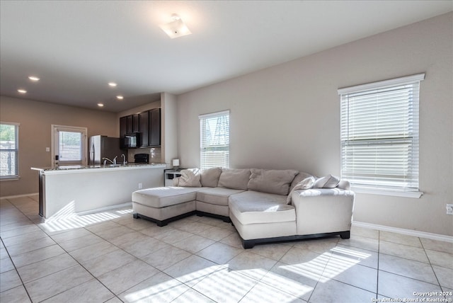 living room featuring a wealth of natural light and light tile patterned flooring