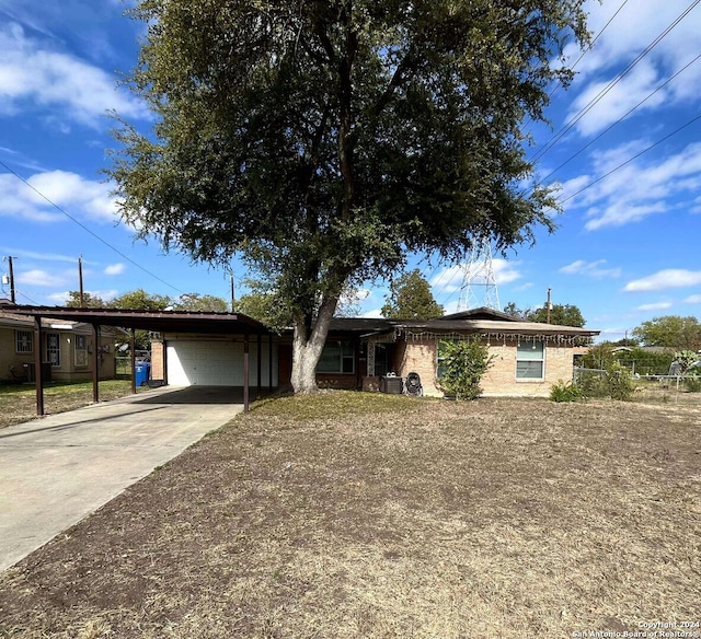 single story home featuring cooling unit and a carport