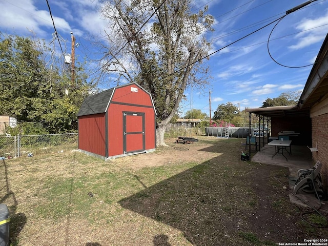 view of yard featuring a storage shed and a patio