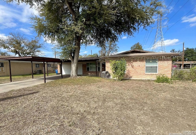 view of front of property featuring central AC and a carport