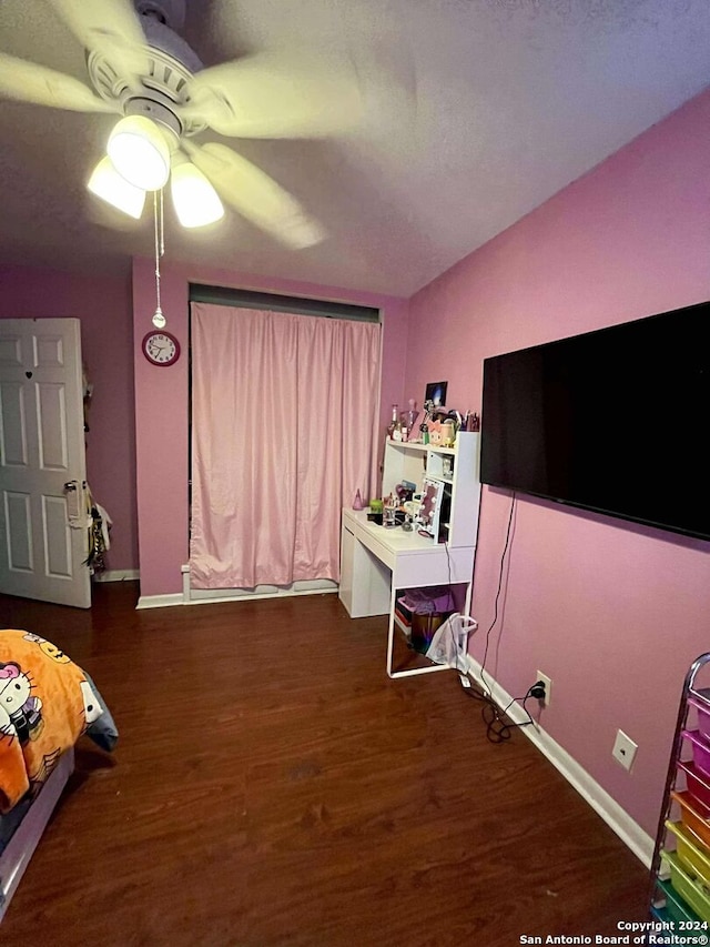 bedroom with ceiling fan and dark wood-type flooring