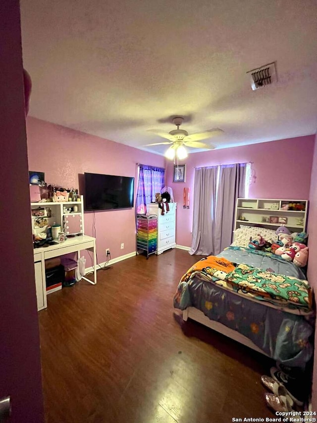 bedroom with ceiling fan and dark wood-type flooring