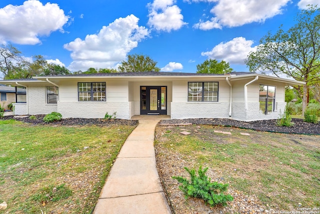 ranch-style home with a front lawn