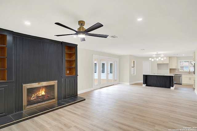 unfurnished living room with hardwood / wood-style floors, ceiling fan, and sink