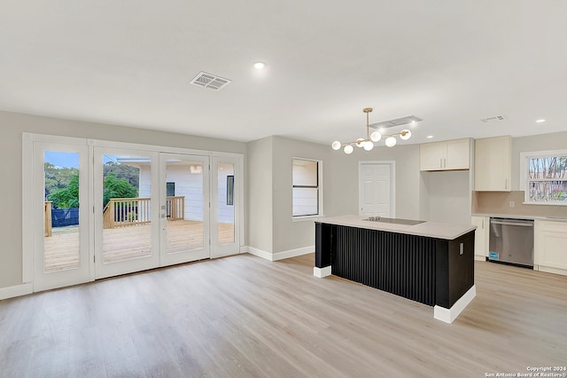 kitchen with dishwasher, a center island, white cabinets, and a wealth of natural light