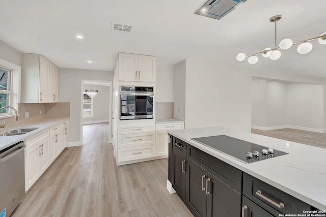 kitchen featuring pendant lighting, plenty of natural light, appliances with stainless steel finishes, and sink