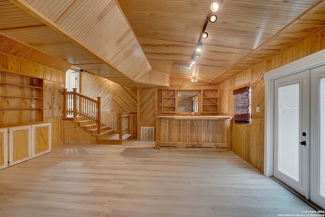 interior space featuring built in features and wooden walls