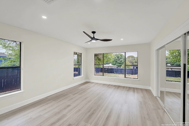 spare room with ceiling fan and light hardwood / wood-style floors