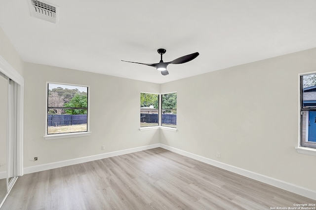 empty room featuring ceiling fan and light hardwood / wood-style flooring