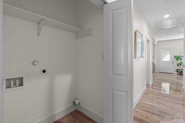 clothes washing area featuring washer hookup, electric dryer hookup, and light hardwood / wood-style flooring