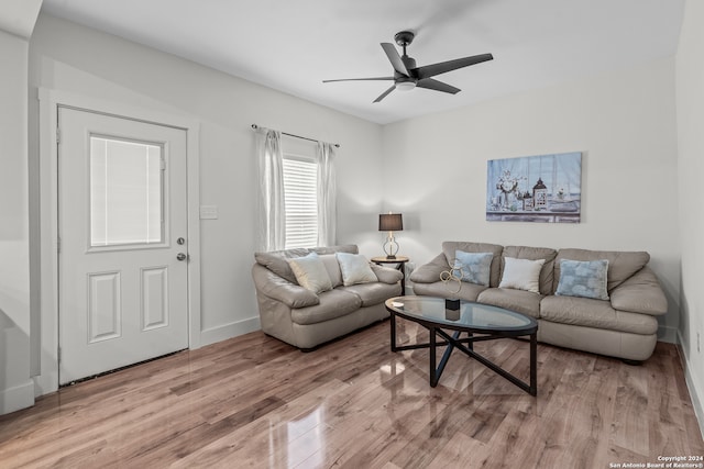 living room with light hardwood / wood-style floors and ceiling fan