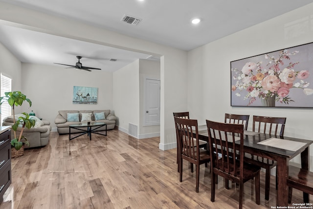 dining space with ceiling fan and light hardwood / wood-style floors